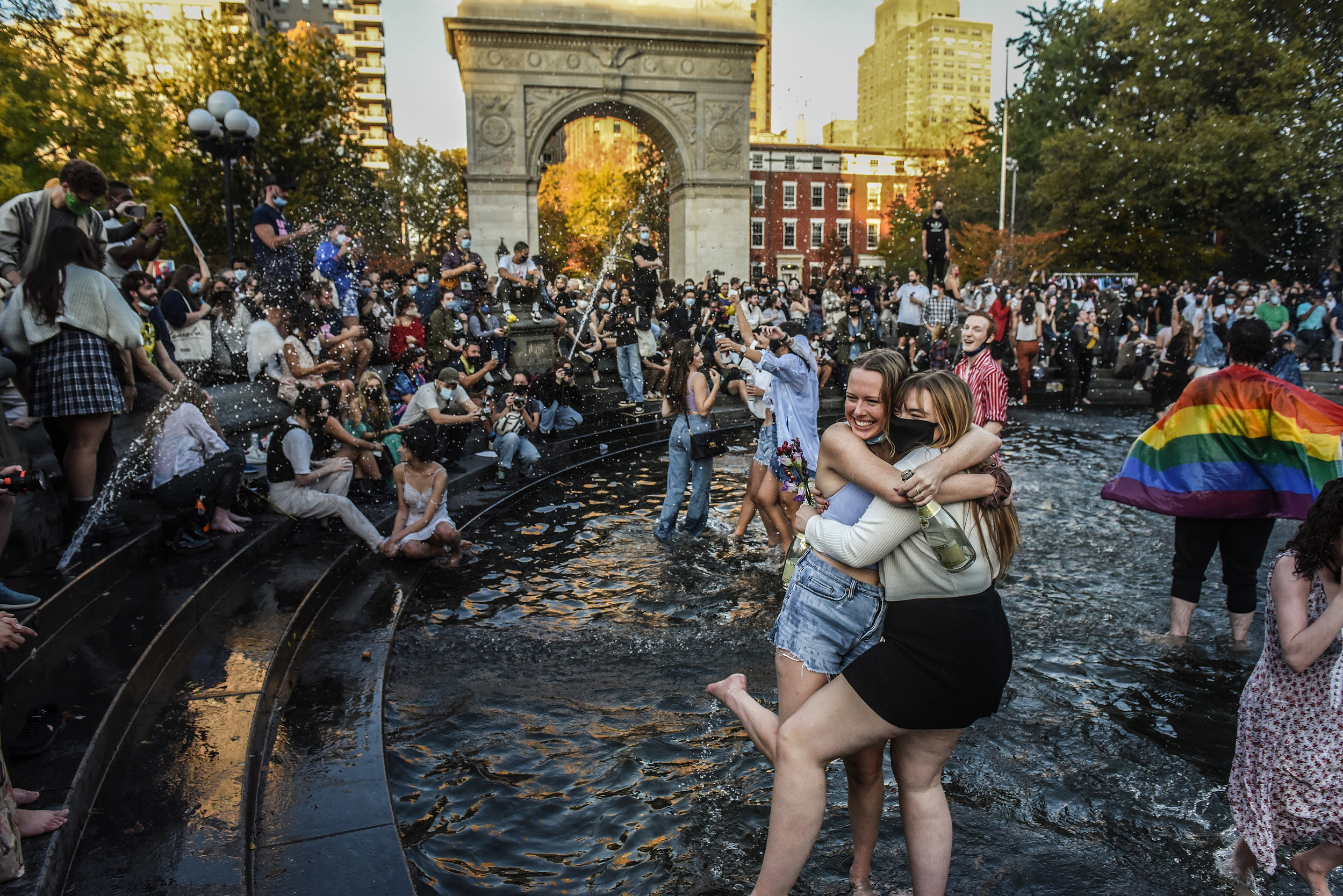 NEW YORK, NY - NOVEMBER 07: Supporters of Joe Biden celebrate on November 7, 2020 in Washington Square Park in New York, United States. According to several news outlets presidential candidate Joe Biden has defeated incumbent U.S. President Donald Trump t